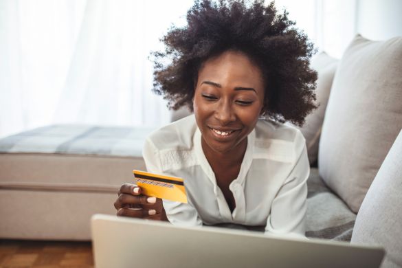 Women lying on couch ready to purchase online